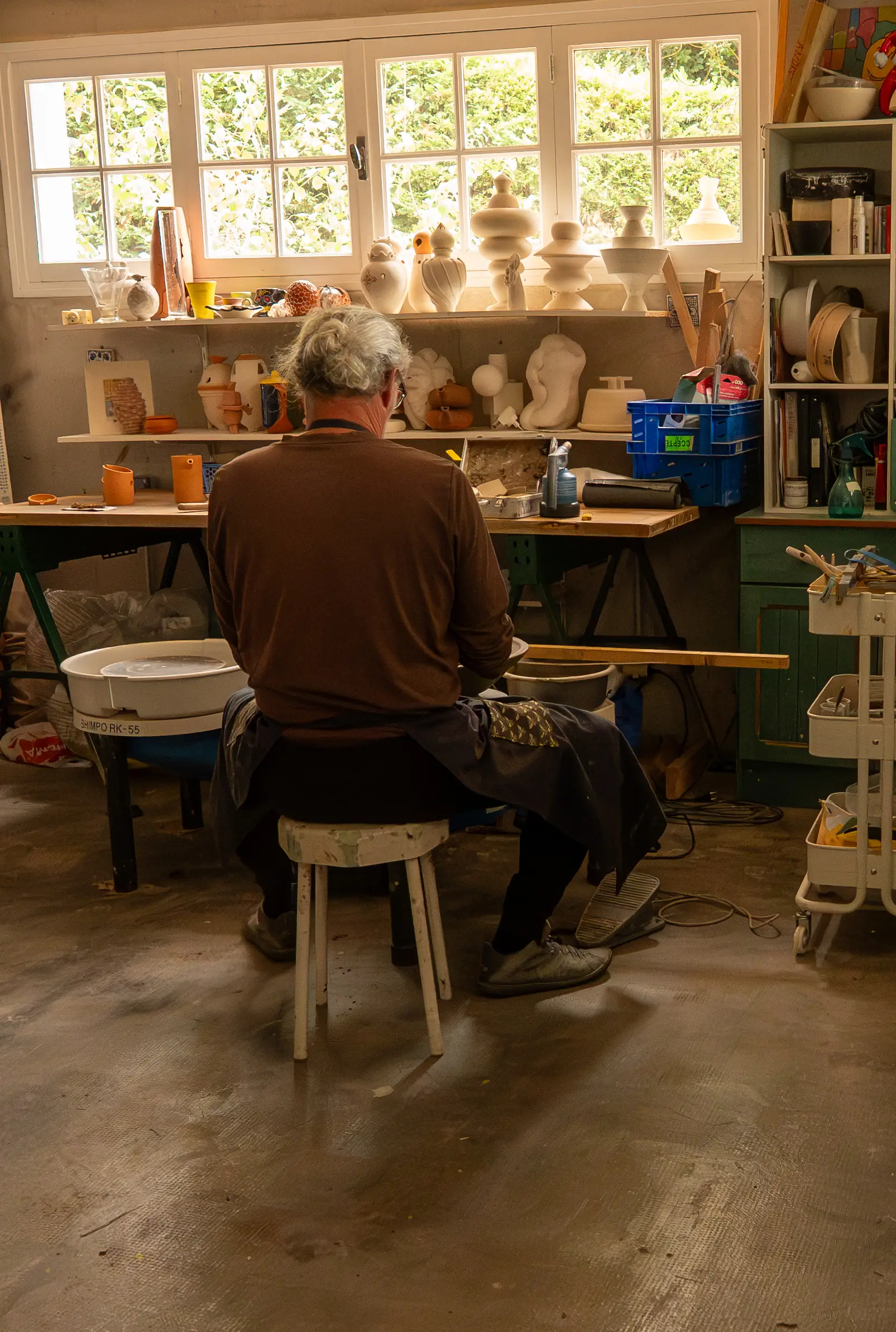 Terracotta jar by Atelier De Maindis integrated into a natural garden landscape