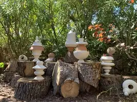 Terres vivantes installation, terracotta jars colonised by vegetation in a natural garden