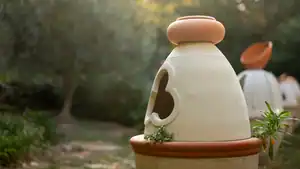 Mediatrix I terracotta sculpture, detail within a natural garden setting